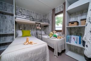 Cozy room with beds, plush toys, and games, serene and joyful atmosphere.