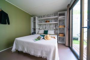 Cozy room with white bed, natural light, and a relaxing atmosphere.