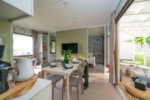 Bright, cozy interior with a set table and sunny veranda.