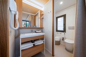 Bagno moderno e accogliente con legno chiaro e luce naturale.