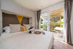 Bright room with cozy bed, view of lush garden.