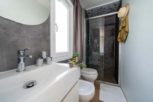 Bright, modern bathroom with elegant shower and cozy details.