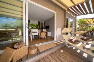 Cozy terrace with loungers overlooking a bright living room.