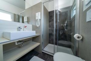 Modern, bright bathroom with elegant shower and minimalist sink.