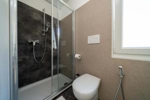 Modern bathroom, sleek shower, clean and bright atmosphere.