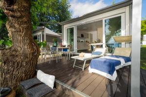 Sunny terrace with loungers and table, perfect for relaxation and nature.