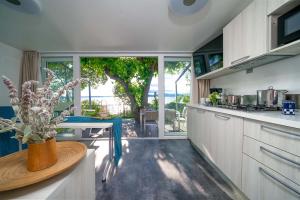 Bright kitchen with lake view and lush nature.