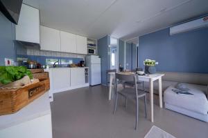 Modern living room with kitchen, cozy and bright atmosphere.