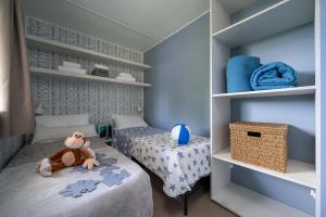 Cozy room with twin beds, toys, and blue decorations.