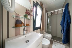 Elegant, bright bathroom with open window and natural accents.
